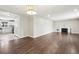 Open living room with hardwood floors, a fireplace, and a view into the bright kitchen at 3179 S University Blvd, Englewood, CO 80113