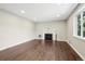 Bright living room features a decorative fireplace, hardwood floors, and natural light from the window at 3179 S University Blvd, Englewood, CO 80113