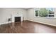 Bright living room with refinished hardwood floors, fireplace, and large windows, creating a warm, welcoming ambiance at 3179 S University Blvd, Englewood, CO 80113