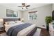 Cozy main bedroom featuring a large window and neutral decor at 3179 S University Blvd, Englewood, CO 80113