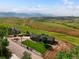 Expansive property featuring rolling green hills and a charming home with a well-manicured lawn at 16535 W 79Th Dr, Arvada, CO 80007