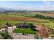Expansive property featuring rolling green hills and a charming home with a well-manicured lawn at 16535 W 79Th Dr, Arvada, CO 80007