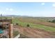 Scenic backyard view showcasing rolling hills and distant mountains from the property at 16535 W 79Th Dr, Arvada, CO 80007