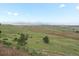 Sweeping backyard view showcasing the picturesque landscapes and distant mountains at 16535 W 79Th Dr, Arvada, CO 80007