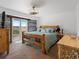 Inviting bedroom with scenic views, wooden accents, and comfortable furnishings at 16535 W 79Th Dr, Arvada, CO 80007