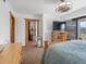 Spacious bedroom with scenic views, cozy bed, and stylish wooden decor at 16535 W 79Th Dr, Arvada, CO 80007