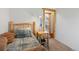 Charming bedroom with a log-style bed frame and a glimpse into another room at 16535 W 79Th Dr, Arvada, CO 80007