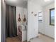 Bright hallway with mandolins on the wall leading to bathroom and bedroom at 16535 W 79Th Dr, Arvada, CO 80007