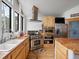 Bright kitchen featuring stainless steel appliances, wood cabinets, and large windows with a farmhouse sink at 16535 W 79Th Dr, Arvada, CO 80007