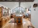 Bright kitchen features wood cabinetry, butcher block island, stainless appliances, wood floors, and vaulted ceilings at 16535 W 79Th Dr, Arvada, CO 80007