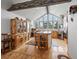 Bright kitchen with wood cabinetry, butcher block island, stainless appliances, wood floors, and vaulted ceilings at 16535 W 79Th Dr, Arvada, CO 80007
