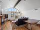 Bright and airy living room with soaring windows, hardwood floors, and comfortable seating at 16535 W 79Th Dr, Arvada, CO 80007