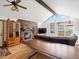 Inviting living room boasts stone fireplace, wood floors, vaulted ceiling and large windows with scenic views at 16535 W 79Th Dr, Arvada, CO 80007