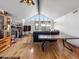 Living room with stone fireplace, wood floors, vaulted ceiling, large windows with scenic views, and rustic decor at 16535 W 79Th Dr, Arvada, CO 80007