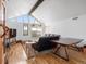 Spacious living room features vaulted ceilings, hardwood floors, comfortable seating, and scenic views from large windows at 16535 W 79Th Dr, Arvada, CO 80007