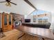 Inviting living room boasts stone fireplace, wood floors, vaulted ceiling and large windows with scenic views at 16535 W 79Th Dr, Arvada, CO 80007