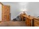 Bright office featuring rustic wooden desk, comfortable seating, and natural light at 16535 W 79Th Dr, Arvada, CO 80007