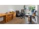 Functional home office space with ample natural light, wooden desk, and ergonomic chair at 16535 W 79Th Dr, Arvada, CO 80007