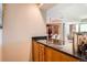 Granite countertop bar area with custom wood cabinets and dining room views at 1900 E Girard Pl # 908, Englewood, CO 80113