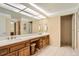 Classic bathroom with double sinks, wood cabinets, and tile flooring at 1900 E Girard Pl # 908, Englewood, CO 80113