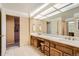 Bathroom featuring double sinks, wood cabinets, and tile flooring at 1900 E Girard Pl # 908, Englewood, CO 80113
