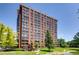 Tall apartment building with many windows on a sunny day at 1900 E Girard Pl # 908, Englewood, CO 80113
