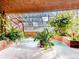 Indoor hot tub surrounded by lush tropical greenery with glass ceiling and brick accents at 1900 E Girard Pl # 908, Englewood, CO 80113
