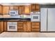 Traditional kitchen features oak cabinets, white appliances, and black countertops, offering functionality at 1900 E Girard Pl # 908, Englewood, CO 80113