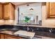 Modern kitchen sink and countertop featuring stainless steel faucet and view to the living area at 1900 E Girard Pl # 908, Englewood, CO 80113