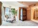 Living area features a chair, armoire, draperies, large windows, chandelier, and peach colored walls at 1900 E Girard Pl # 908, Englewood, CO 80113