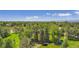 Picturesque aerial view of a serene pond surrounded by lush greenery and mature trees, a tranquil escape at 1900 E Girard Pl # 908, Englewood, CO 80113