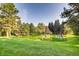 Scenic view of a tranquil pond surrounded by lush green grass and mature trees creating a peaceful oasis at 1900 E Girard Pl # 908, Englewood, CO 80113