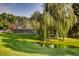 Scenic pond and verdant lawn offer a tranquil setting near the tennis court for peaceful relaxation and recreation at 1900 E Girard Pl # 908, Englewood, CO 80113