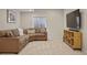 Cozy basement living room with a large sectional couch, TV, and neutral colors at 3476 Beeler Ct, Denver, CO 80238