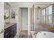 Elegant bathroom features a soaking tub, glass shower and granite countertop vanity at 3476 Beeler Ct, Denver, CO 80238