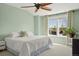 Bright bedroom with a ceiling fan, large window and light green walls at 3476 Beeler Ct, Denver, CO 80238