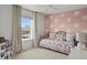 Charming bedroom features a fun accent wall, carpet, and neutral curtains at 3476 Beeler Ct, Denver, CO 80238