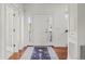 Bright foyer with a white front door, hardwood floors, and a decorative rug at 3476 Beeler Ct, Denver, CO 80238