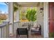 Cozy front porch features comfortable seating, a hanging plant, and a charming outdoor ambiance at 3476 Beeler Ct, Denver, CO 80238