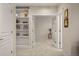 Hallway with carpeted floors, built-in bookshelves, and double doors leading to another room at 3476 Beeler Ct, Denver, CO 80238
