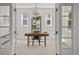 Bright home office with stylish desk, shelving, and natural light from multiple windows at 3476 Beeler Ct, Denver, CO 80238