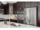 Modern kitchen with stainless steel appliances, dark cabinetry, and a white countertop at 3476 Beeler Ct, Denver, CO 80238