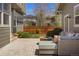 Back patio features a fire pit, comfortable seating, and a beautifully landscaped yard at 3476 Beeler Ct, Denver, CO 80238