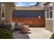 Back patio with stone pavers, a fire pit, and comfortable outdoor furniture at 3476 Beeler Ct, Denver, CO 80238