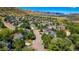 Neighborhood aerial view with mature trees and well-maintained homes and mountain views at 469 Tripp Dr, Golden, CO 80401