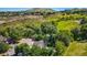 Aerial view of a neighborhood nestled among mature trees with mountain views at 469 Tripp Dr, Golden, CO 80401