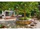 Beautiful backyard with a tree-lined patio area, outdoor seating, and lush landscaping providing shade and privacy at 469 Tripp Dr, Golden, CO 80401