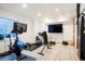 Finished basement used as a home gym, complete with exercise equipment and mounted televisions at 469 Tripp Dr, Golden, CO 80401