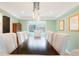 Bright dining room featuring a dark wood table, white chairs, and stylish lighting fixture, with a large window view at 469 Tripp Dr, Golden, CO 80401