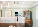 An open-concept dining room with a light-green color scheme and a wood china cabinet next to the dining table at 469 Tripp Dr, Golden, CO 80401